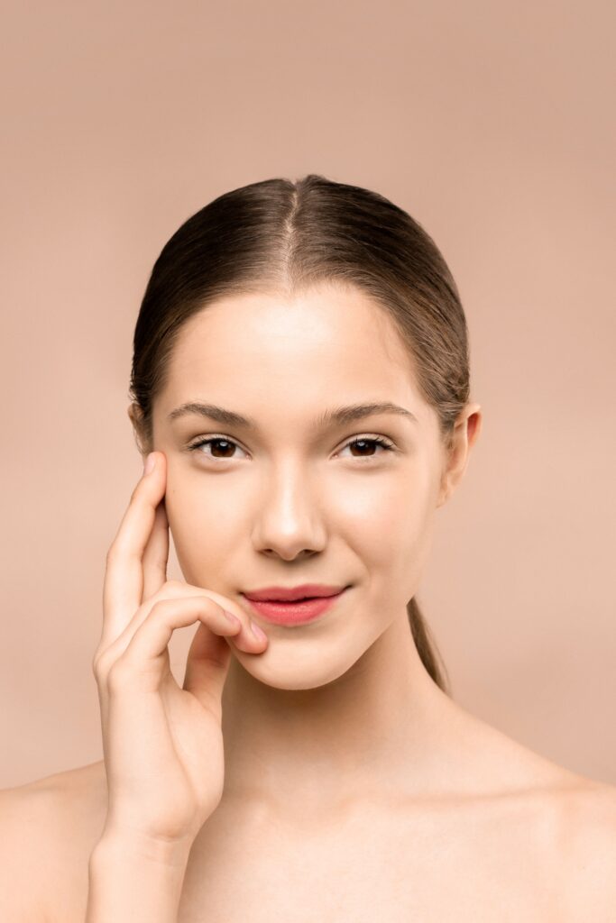 Woman with naturally glowing healthy skin following a skincare routine